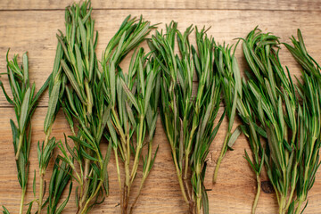 Tasty and aromatic rosemary on a wooden table. Healthy food