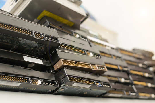 a lot of hard drives from the computer are on the top shelf of the rack against the background of the white ceiling