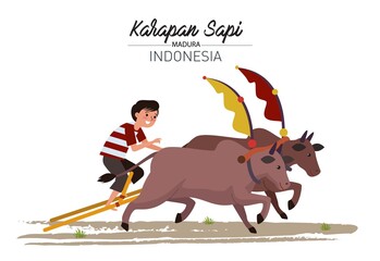 A boy racing in a cow racing from Madura Island, East Java.  In this race, a pair of cows pulling a kind of wooden chariot are driven in a race to compete against other pairs of cows.