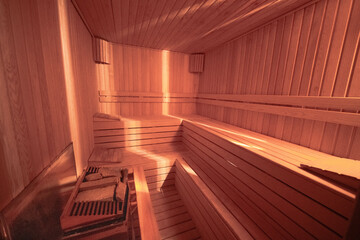 Fototapeta na wymiar sauna bathhouse warm interior inside empty brooms barrels bucket for water,Interior of Finnish sauna, classic wooden sauna