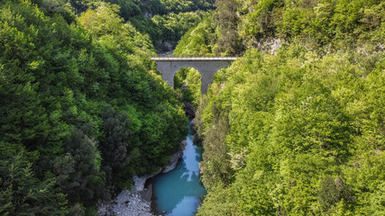Fototapeta na wymiar Lavelle bridge between Cerreto Sannita and Cusano Mutri in Benevento, Italy. This place is famous in Italy due to the erosion of the rocks by the river. Perfect place for trekking and nature lovers.
