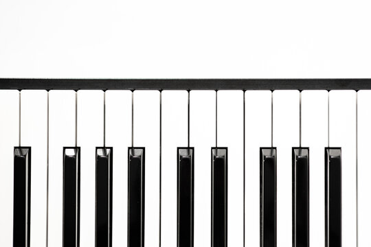  Piano keyboard on white background, top view layout, free space, white and black keys on the synthesizer