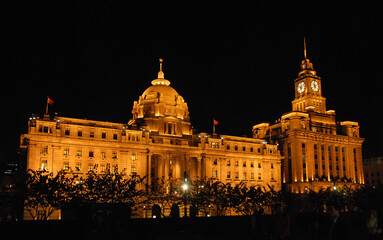 Fototapeta na wymiar The Bund in Shanghai, China. The Bund is a riverfront area in central Shanghai with many historic concession era buildings. The illuminations on the Bund at night are popular with tourists in Shanghai