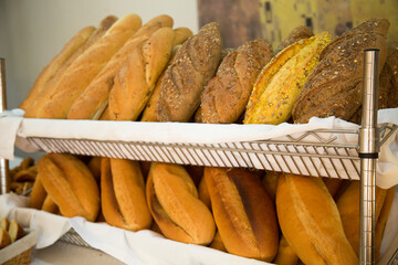 Bakery products many loaves of bread are on the counter.