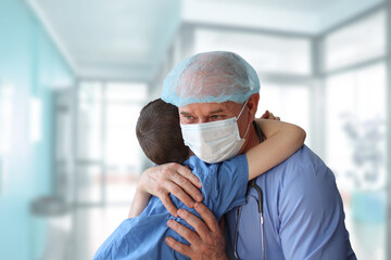 little patient is hugged by a male doctor, therapist, pediatrician, concept of medical treatment, insurance, professional care and trust, gratitude