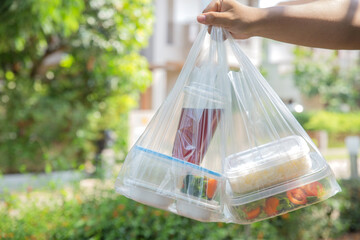  food boxes in plastic bags delivered to customer at home by delivery man .delivery service during covid19