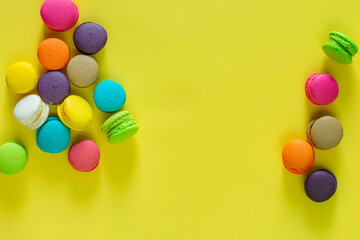 Sweet and colorful french macaroons or macaroon on yellow background, Dessert eating with tea or coffee.