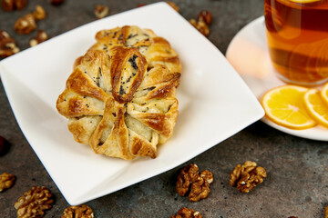 Beautiful pastries on a square white plate. Fresh aromatic pastries for breakfast or snack.