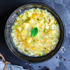 soup vegetables and pasta alphabet, peas, corn Menu concept healthy eating. food background top view copy space for text table setting keto or paleo diet