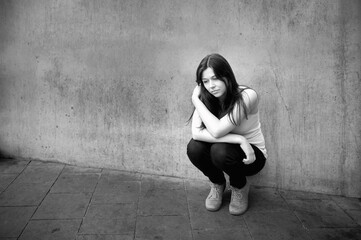 Teenage girl looking thoughtful about troubles, black and white photo