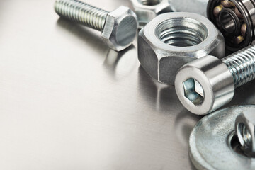 Obraz premium nuts, bolts, screws, washers, bearings on a metal steel background.