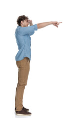 curious casual man holding hand to forehead and pointing finger