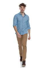 Fototapeta premium happy casual man in denim shirt smiling and walking