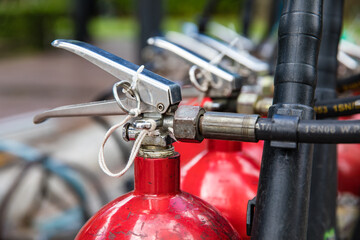 Close up of head latch and pin of red extinguishers