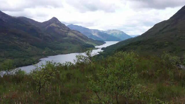 aerial footage of loch leven and the pap of glencoe shot on the west highland way near kinlochleven in the argyll region of the highlands of scotland in summer
