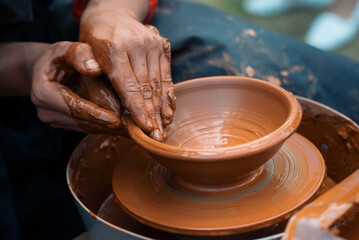 Fototapeta na wymiar Hands of the potter. The potter makes pottery dishes on potter