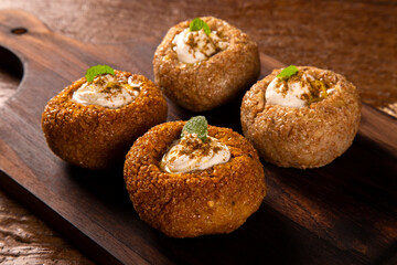 kibe stuffed with dry curd on wood background.