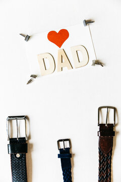 Dad I love you message. Greetings for Father's Day. Happy Fathers Day background with stylish belts and cufflinks. Overhead view