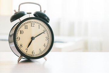 alarm clock on the table in the room, selective focus, tinted image