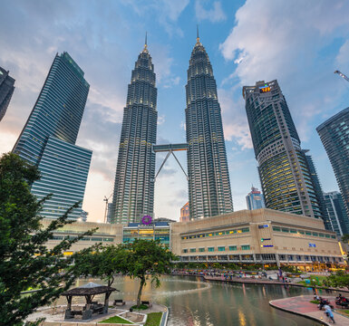 Kuala Lumpur, Malaysia - March 14, 2016: Petronas TwinTowers and Suria KLCC shopping mall at sunset, Kuala Lumpur, Malaysia on March 14, 2016.