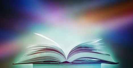 The blurred book that is bewitched with magic, the magic light in the dark, with the bright light shining down as the power to search for knowledge. For research and use as a blurred background