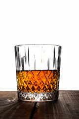 Glass with whiskey or rom with ice cubes.
