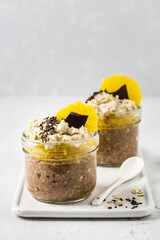 Vegan dark chocolate cirus peanut butter overnight oats in glasses.  Selective focus, copy space.