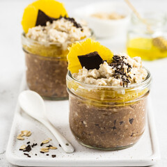 Pumpkin citrus fall cocoa overnight oats in glasses.  Selective focus, copy space.