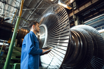 Engineer checks turbine impeller vanes, factory - obrazy, fototapety, plakaty