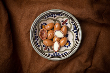 Argan seeds  on a dark background. Argan oil based cosmetics concept.
