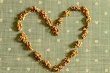 Peeled California Walnut Heart On Blue Background With White Dots