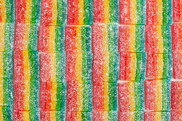 Striped, colorful marmalade in the sugar pattern. Rainbow colored marmalade candy. 