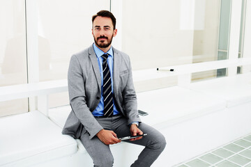 Male specialist in the legal profession is using digital tablet before interview