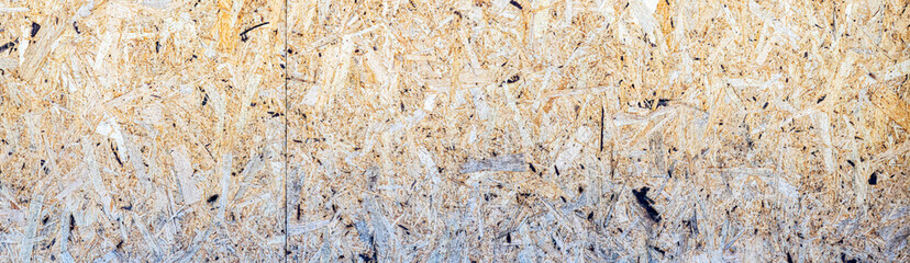 Pressed wood chipboard surface panorama. Close-up of a chipboard.