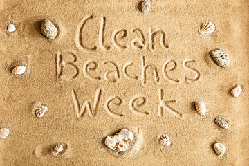 Fototapeta na wymiar Ecology - clean beaches week. Eco initiative name on the sand.