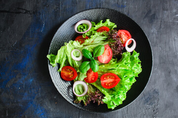 Healthy vegetable salad leaves lettuce mix micro green, cucumber, tomato, onion other ingredient. food background copy space 