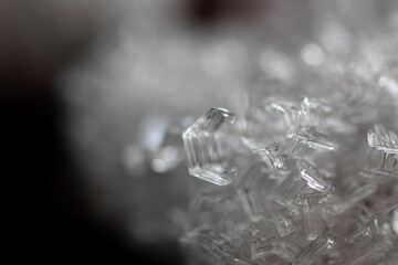 Close up of the crystalline texture of ice in the freezer. Frozen water, formation of frost crystals.