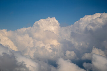 White clouds and blue sky, a view from airplane window
