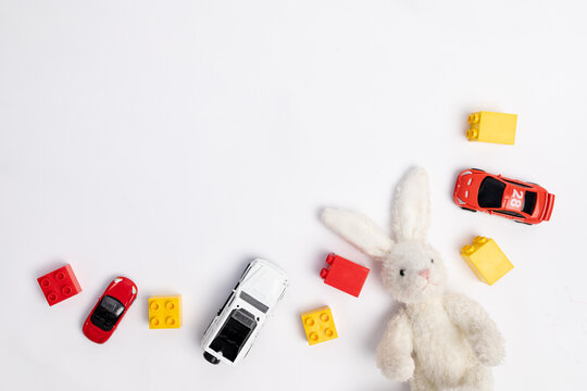 toys constuctor and cars, top view on white background, place for text