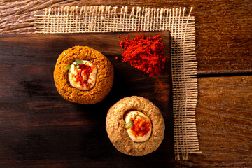 kibe stuffed with dry curd on wood background.