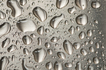Water droplets on brushed stainless steel background
