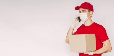 Banner happy delivery guy in uniform, medical face mask, protective gloves talk mobile phone, hold cardboard box isolated on white background, copy space. Delivery service worker carry parcel package