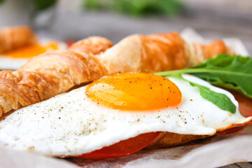 Morning Breakfast with scrambled eggs, croissant and rucola