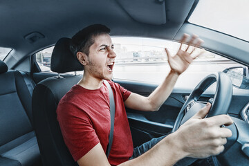 Angry man driver reacts aggressively to other road users. Concept of psychological problems, anger,...