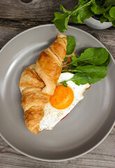Morning Breakfast with scrambled eggs, croissant and rucola