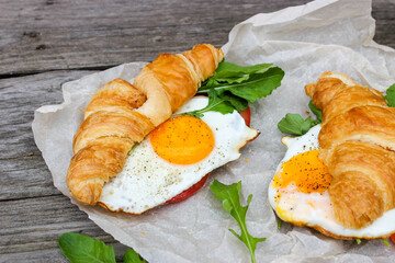 Morning Breakfast with scrambled eggs, croissant and rucola