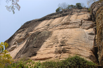 Fototapeta na wymiar Wuyishan mountains in Fujian Province, China. On the path to DaWang (Great King) Peak. The mountain has steep cliffs and the path is inside the crack in the rock. Wuyishan is a UNESCO site in China.