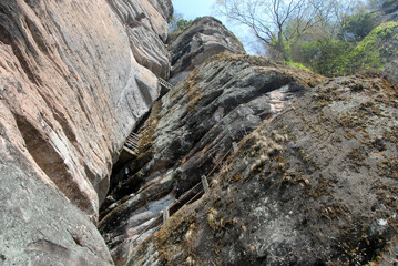 Wuyishan mountains in Fujian Province, China. On the path to DaWang (Great King) Peak. The mountain has steep cliffs and the path is inside the crack in the rock. Wuyishan is a UNESCO site in China.