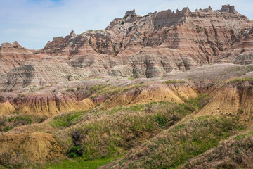 Muted colors against arid rugged rocks create beautiful contrasts in the Badlands national Park in South Dakota.