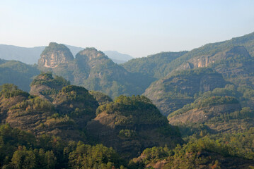 Wuyishan mountains in Fujian Province, China. Scenic view over the peaks of Wuyi mountains. A classic view of the hills from Roaring Tiger Rock. Wuyishan is a UNESCO World Heritage site in China.